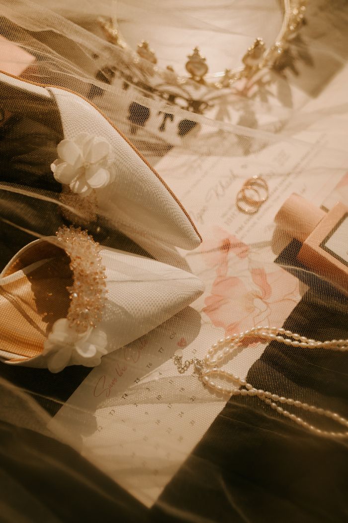 services-bg Chic flat lay of bridal shoes, veil, necklace, and headband for wedding inspiration.