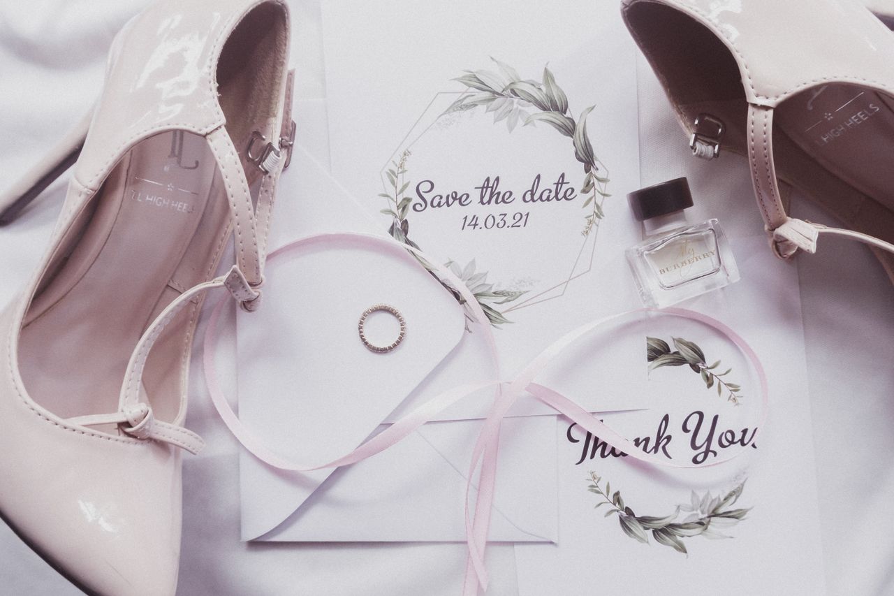 home-hero A chic flat lay of wedding essentials including heels, perfume, and invitations.